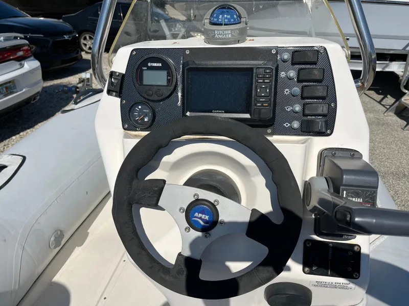 Slide: The Image of Steering console of 2014 Apex A-11 Tender boat with navigation instruments and controls. - 10