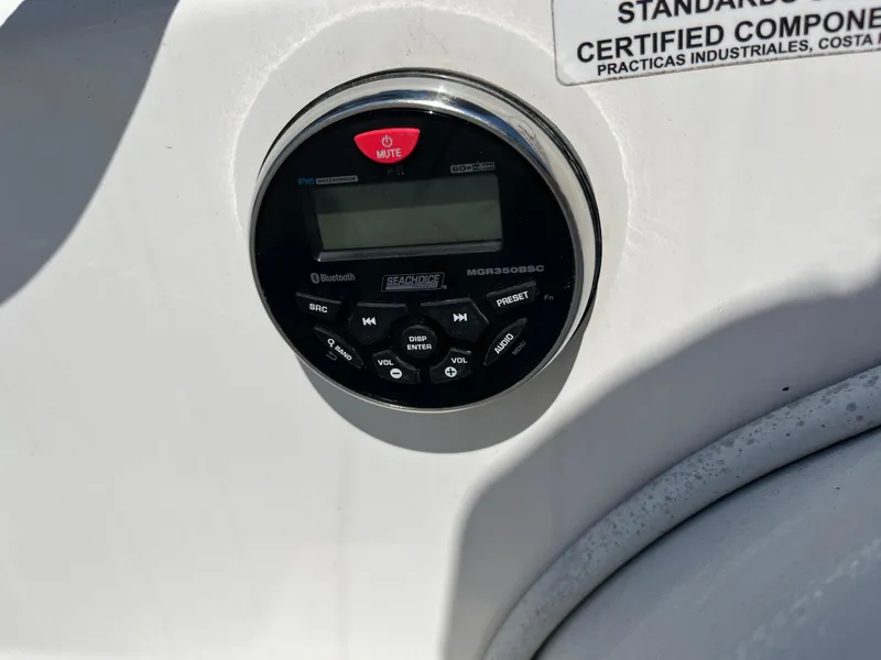 Slide: The Image of Control panel on 2014 Apex A-11 Tender boat, featuring audio system and certification label. - 12