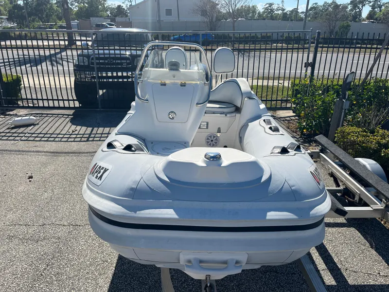 Slide: The Image of 2014 Apex A-11 Tender boat on trailer, parked outdoors in a sunny setting. - 3