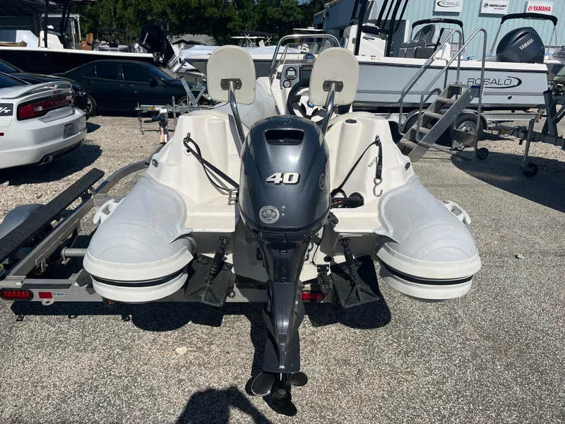Slide: The Image of 2014 Apex A-11 Tender boat with 40 HP outboard motor on trailer. - 7