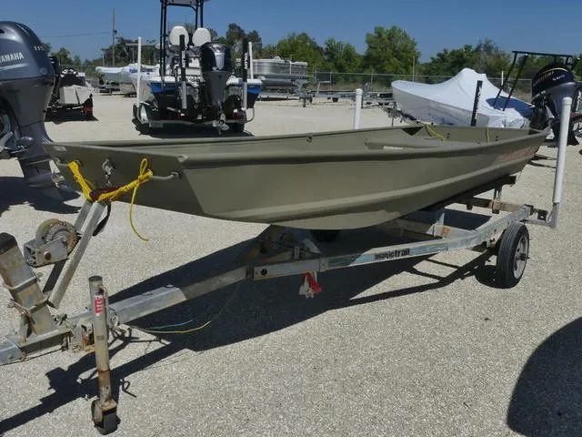 Slide: The Image of 2025 Tracker Grizzly® 15 Jon boat on trailer, parked outdoors. - 3