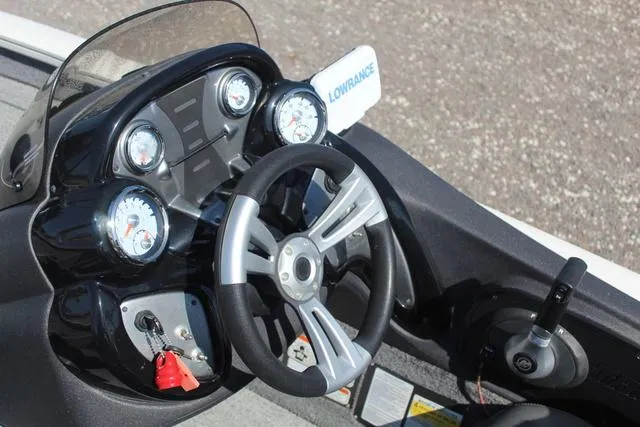 Slide: The Image of 2021 Tracker Pro Team 175 TXW Tournament Edition boat dashboard with steering wheel and gauges. - 13