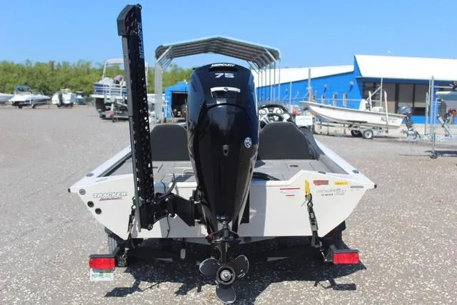 Slide: The Image of 2021 Tracker Pro Team 175 TXW Tournament Edition boat with Mercury 75 engine, parked outdoors. - 5