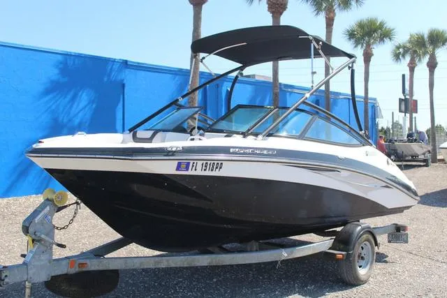 Slide: The Image of 2014 Yamaha Boats AR192 on trailer, parked outdoors with palm trees in background. - 1