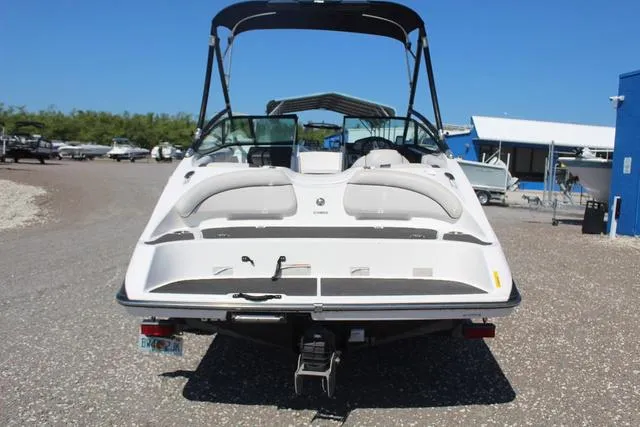 Slide: The Image of 2014 Yamaha Boats AR192, rear view, parked on gravel, with canopy and seating visible. - 5