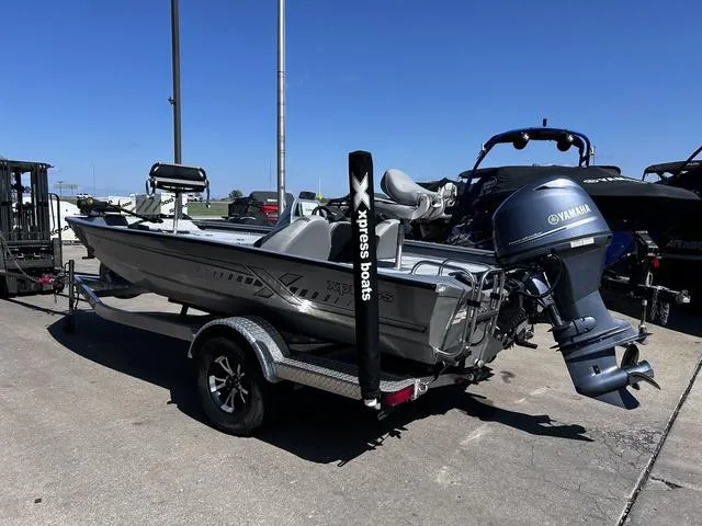 Slide: The Image of 2023 Xpress Boats H17 with Yamaha motor on trailer, parked outdoors. - 4