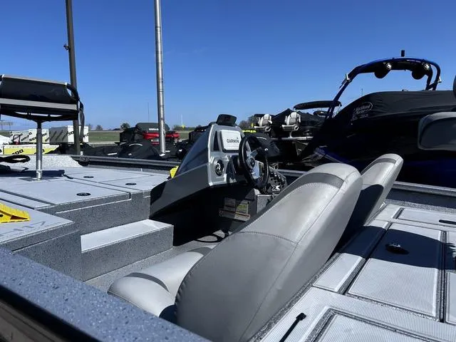 Slide: The Image of 2023 Xpress Boats H17 interior with steering console and seating, under clear blue sky. - 5