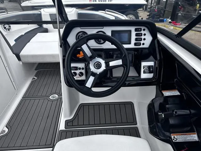 Slide: The Image of 2020 Yamaha AR210 boat cockpit with steering wheel and control panel. - 11