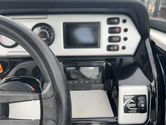 Slide: The Image of Dashboard of a 2020 Yamaha AR210 boat with steering wheel and control panel. - 13