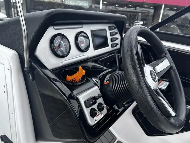 Slide: The Image of 2020 Yamaha AR210 boat dashboard with steering wheel and control gauges. - 14