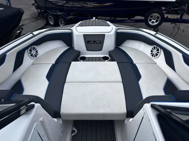 Slide: The Image of 2020 Yamaha AR210 boat interior with cushioned seating and cup holders. - 15