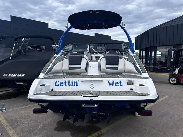 Slide: The Image of 2020 Yamaha AR210 boat with "Gettin' Wet" text on the stern, parked outdoors. - 4