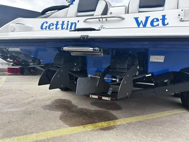 Slide: The Image of 2020 Yamaha AR210 boat with "Gettin' Wet" name, dual engines, parked on concrete. - 5