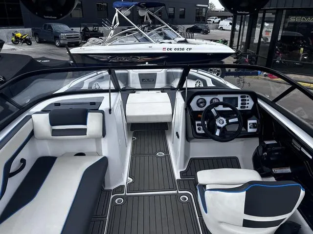 Slide: The Image of 2020 Yamaha AR210 boat interior with sleek seating and modern dashboard design. - 9