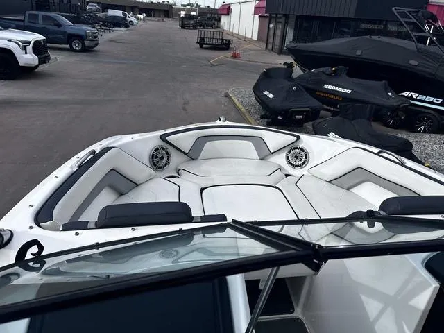 Slide: The Image of 2015 Yamaha Boats AR192 interior with seating and speakers, parked in a dealership lot. - 11
