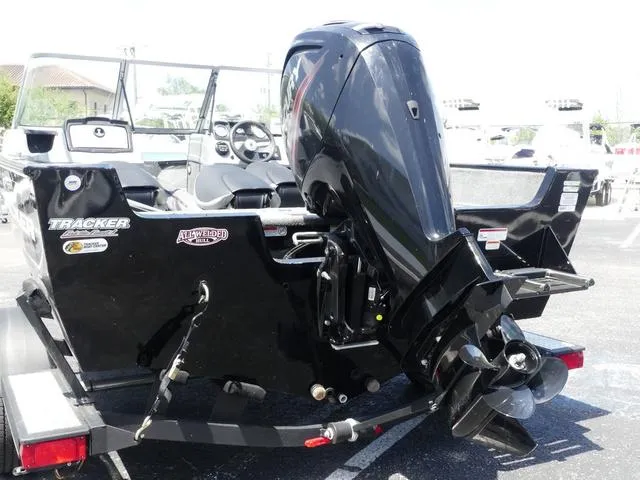 Slide: The Image of 2019 Tracker Pro Guide V-165 WT boat with powerful outboard motor, parked on trailer. - 4