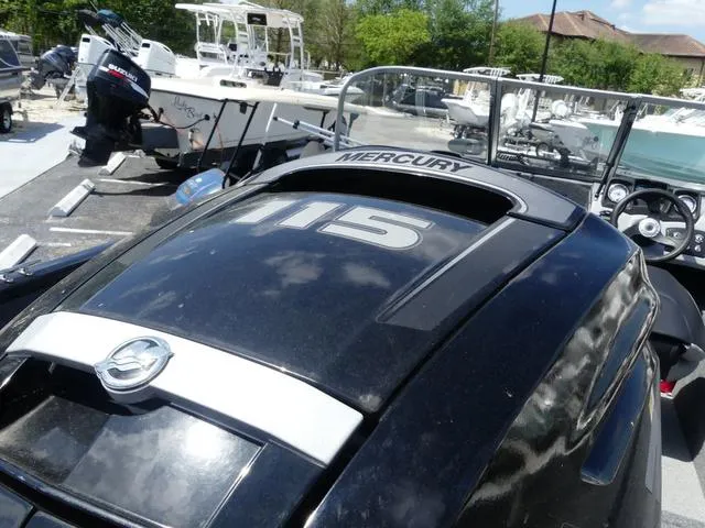 Slide: The Image of 2019 Tracker Pro Guide V-165 WT with Mercury 115 engine, parked outdoors. - 6