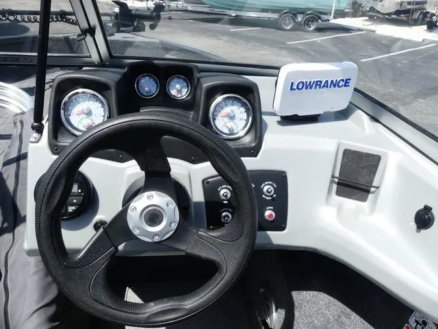 Slide: The Image of 2019 Tracker Pro Guide V-165 WT dashboard with steering wheel and Lowrance navigation system. - 8