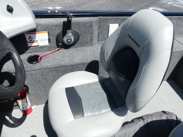 Slide: The Image of 2019 Tracker Pro Guide™ V-165 WT boat interior with gray seating and steering wheel. - 9