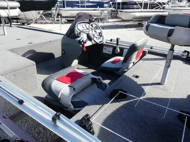 Slide: The Image of 2014 Tracker Pro 170 boat interior with steering console and seating. - 10
