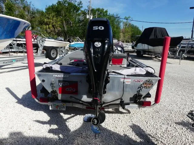 Slide: The Image of 2014 Tracker Pro 170 boat with 50 HP motor in a gravel lot. - 5