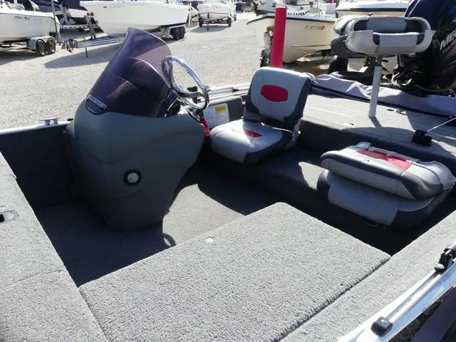 Slide: The Image of 2014 Tracker Pro 170 boat interior with steering console and seating. - 9