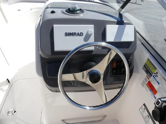 Slide: The Image of Steering console of 2015 Pursuit Boats DC 235 with Simrad electronics. - 10