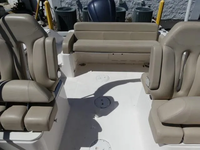 Slide: The Image of 2015 Pursuit Boats DC 235 interior with beige seating and spacious layout. - 15