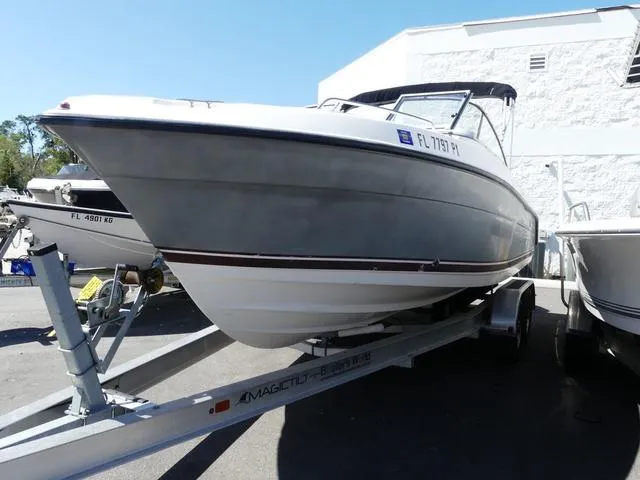 Slide: The Image of 2015 Pursuit Boats DC 235 on trailer, parked outdoors, side view. - 3
