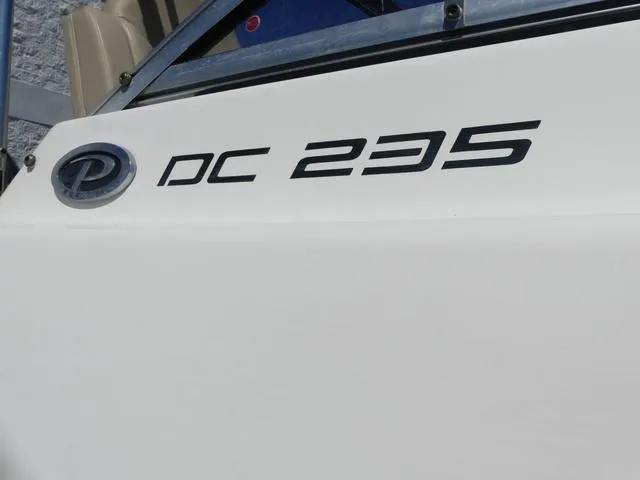Slide: The Image of 2015 Pursuit Boats DC 235 logo on white boat exterior. - 4