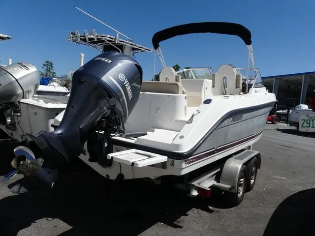 Slide: The Image of 2015 Pursuit Boats DC 235 on trailer with Yamaha outboard motor, parked outdoors. - 6