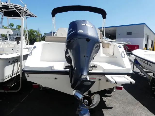 Slide: The Image of 2015 Pursuit Boats DC 235 with Yamaha outboard motor, docked at a marina. - 7