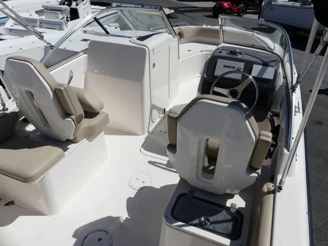 Slide: The Image of 2015 Pursuit Boats DC 235 interior with helm, seating, and dashboard. - 8