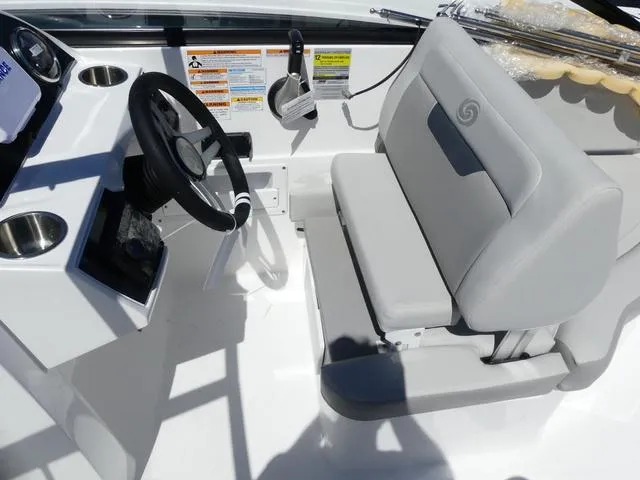 Slide: The Image of 2025 Hurricane SunDeck 235 OB boat interior with steering wheel and seating. - 10