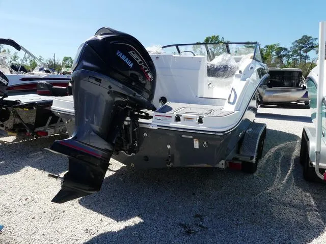 Slide: The Image of 2025 Hurricane SunDeck 235 OB boat with Yamaha outboard motor, parked on gravel. - 5