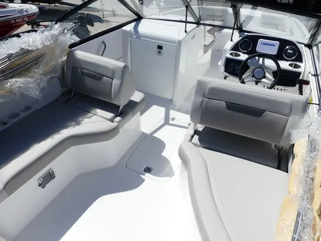 Slide: The Image of 2025 Hurricane SunDeck 235 OB boat interior with modern seating and dashboard. - 7
