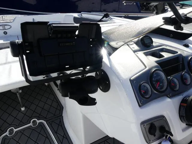Slide: The Image of 2022 Tahoe 2150 boat dashboard with gauges and electronic device holder. - 11