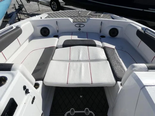 Slide: The Image of 2022 Tahoe 2150 boat interior with white cushioned seating and speakers. - 13