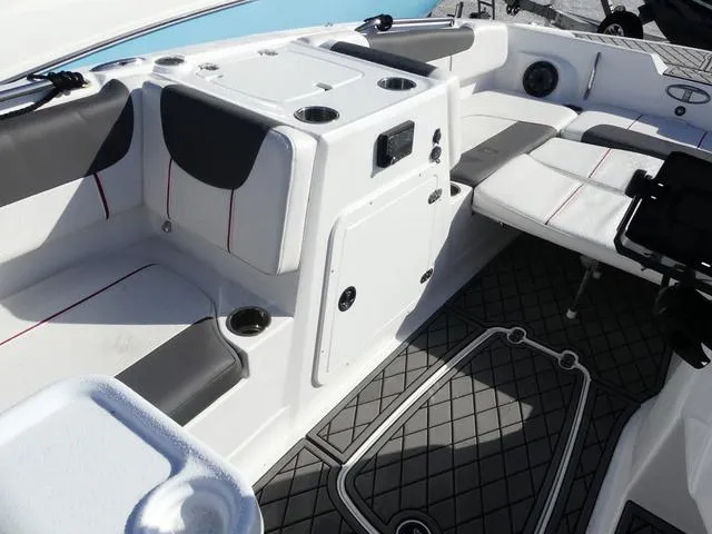 Slide: The Image of 2022 Tahoe 2150 boat interior with seating, cup holders, and storage compartments. - 15