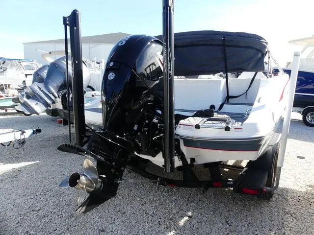 Slide: The Image of 2022 Tahoe 2150 boat with powerful outboard motor, displayed on gravel lot. - 7
