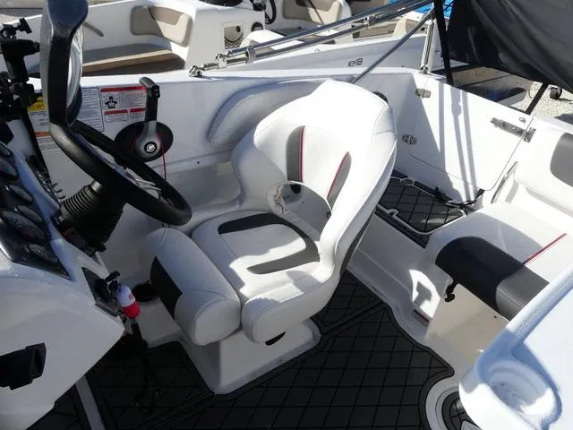 Slide: The Image of 2022 Tahoe 2150 boat interior with white seating and steering wheel. - 9