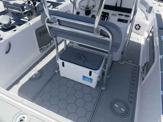 Slide: The Image of 2025 Twin Vee 240 Center Console STX boat dashboard with steering wheel and controls. - 10