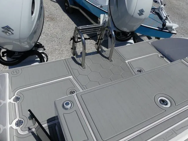 Slide: The Image of 2025 Twin Vee 240 Center Console STX boat helm with steering wheel and controls. - 11