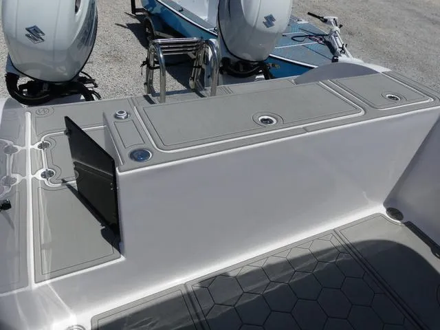 Slide: The Image of 2025 Twin Vee 240 Center Console STX boat dashboard with steering wheel and controls. - 12