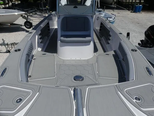 Slide: The Image of 2025 Twin Vee 240 Center Console STX boat interior with seating and storage compartments. - 16