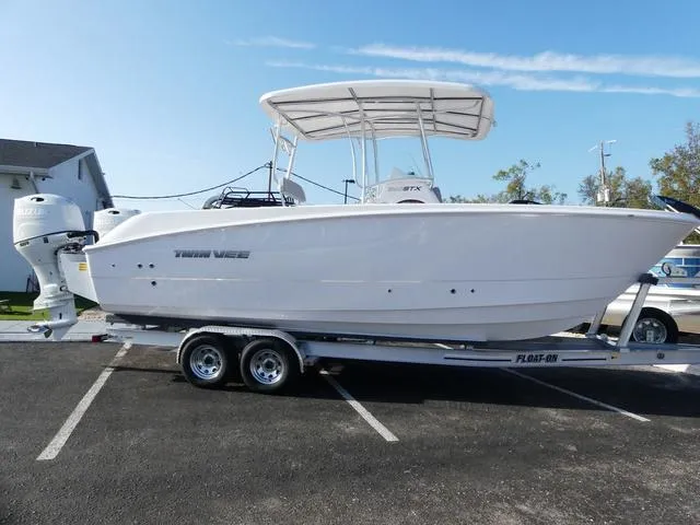 Slide: The Image of 2025 Twin Vee 240 Center Console STX boat interior with steering wheel and seating area. - 20