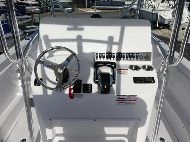Slide: The Image of 2025 Twin Vee 240 Center Console STX boat interior with seating and console view. - 25