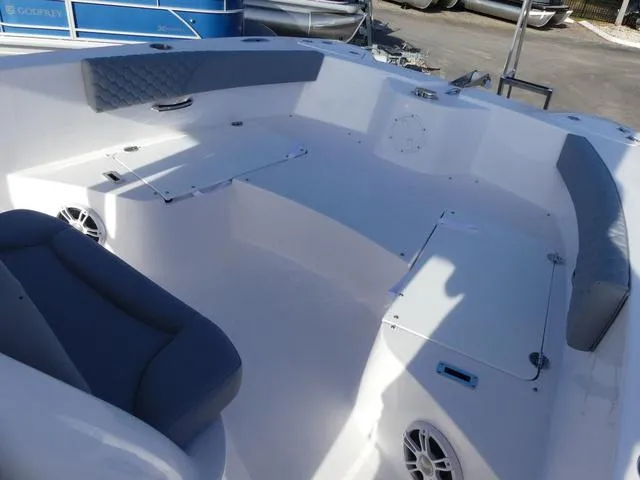 Slide: The Image of 2025 Twin Vee 240 Center Console STX boat interior, featuring sleek white design and stainless steel accents. - 27