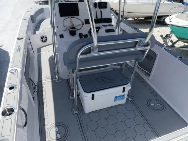 Slide: The Image of 2025 Twin Vee 240 Center Console STX boat on trailer in parking lot. - 3