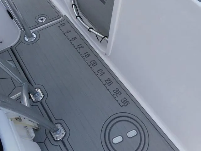 Slide: The Image of 2025 Twin Vee 240 Center Console STX boat with dual Suzuki engines on a trailer. - 5